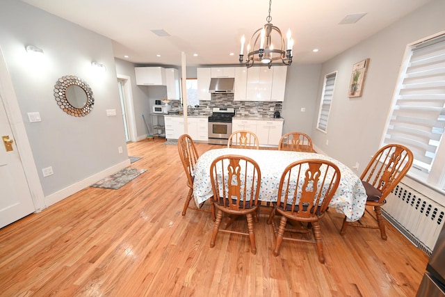 165 Page Rd, Valley Stream, NY 11581 - dining space featuring a chandelier, light wood finished floors, recessed lighting, baseboards, and radiator heating unit