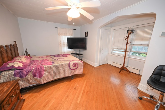 165 Page Rd, Valley Stream, NY 11581 - bedroom with a baseboard heating unit, crown molding, wood finished floors, baseboards, and a ceiling fan