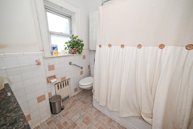 165 Page Rd, Valley Stream, NY 11581 - bathroom featuring radiator, tile walls, toilet, a wainscoted wall, and brick patterned floors