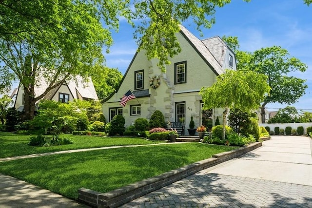 329 Brower Ave, Rockville Centre, NY 11570 - tudor house featuring a front lawn and stucco siding
