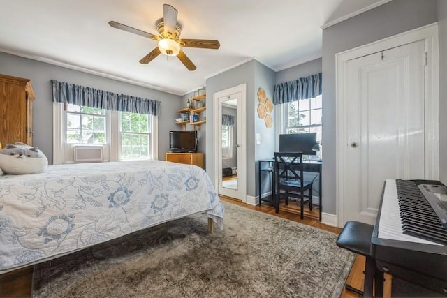 329 Brower Ave, Rockville Centre, NY 11570 - bedroom featuring crown molding, wood finished floors, baseboards, ceiling fan, and a desk