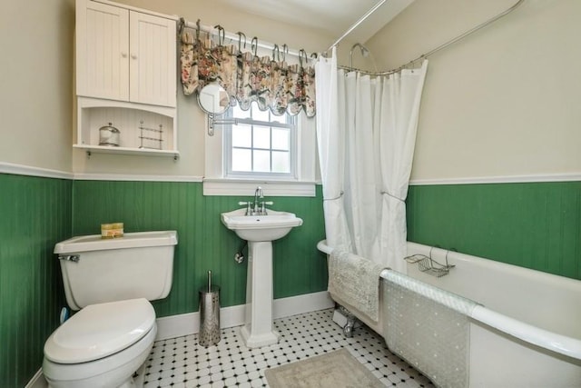 329 Brower Ave, Rockville Centre, NY 11570 - full bathroom with a wainscoted wall and toilet