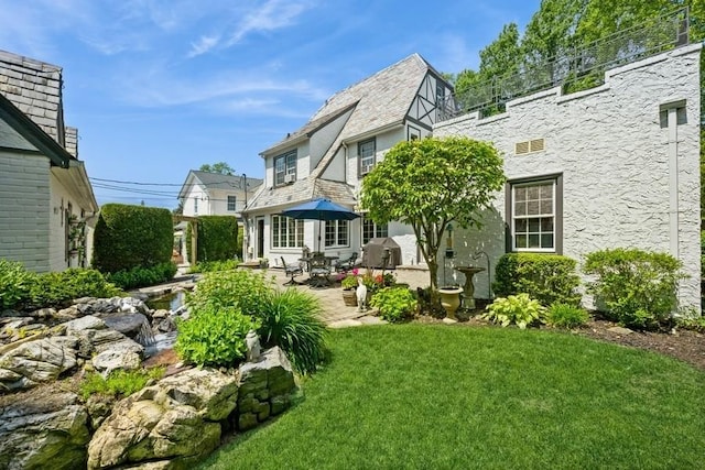 329 Brower Ave, Rockville Centre, NY 11570 - rear view of property with a patio, a lawn, and stucco siding