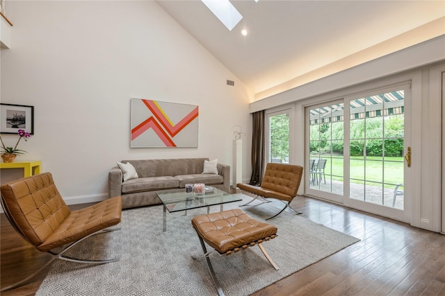 124 Pond View Dr Unit 317, Port Washington, NY 11050 - living area with a skylight, high vaulted ceiling, hardwood / wood-style floors, recessed lighting, and baseboards