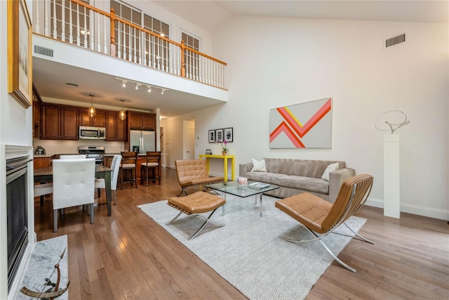 124 Pond View Dr Unit 317, Port Washington, NY 11050 - living area featuring high vaulted ceiling, wood finished floors, and baseboards