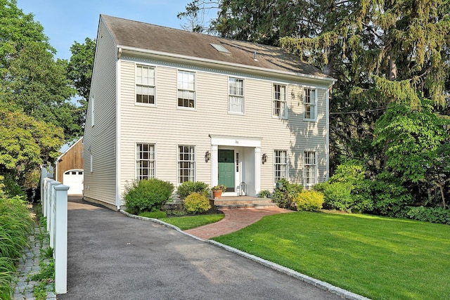 38 Maple Ave, Northport, NY 11768 - colonial house featuring a front yard and a garage