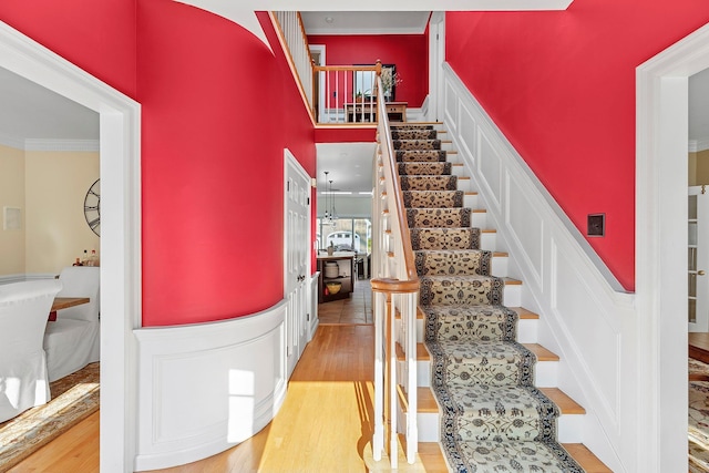 38 Maple Ave, Northport, NY 11768 - stairway with ornamental molding, wood finished floors, and a high ceiling