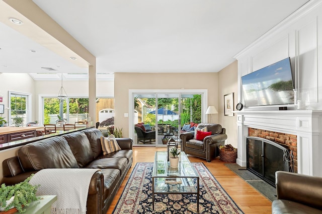 38 Maple Ave, Northport, NY 11768 - living room featuring light wood-type flooring, healthy amount of natural light, a fireplace, and recessed lighting