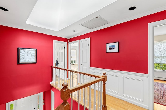 38 Maple Ave, Northport, NY 11768 - hall with an upstairs landing, a baseboard heating unit, light wood finished floors, crown molding, and wainscoting