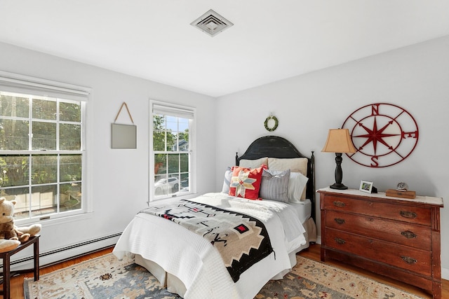 38 Maple Ave, Northport, NY 11768 - bedroom featuring wood finished floors and a baseboard radiator