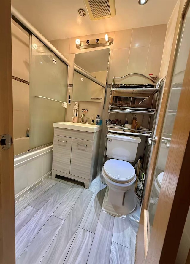 138-70 Elder Ave Unit 3C, Flushing, NY 11355 - full bath with toilet, vanity, and bath / shower combo with glass door