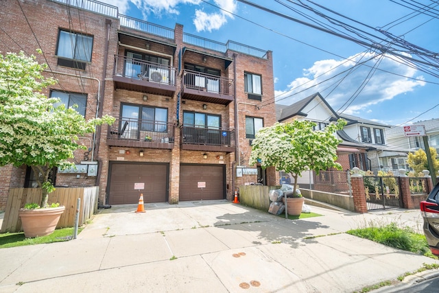 17524 89th Ave Unit C, Jamaica, NY 11432 - view of property with driveway and an attached garage