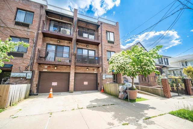 17524 89th Ave Unit C, Jamaica, NY 11432 - view of building exterior with driveway and a garage