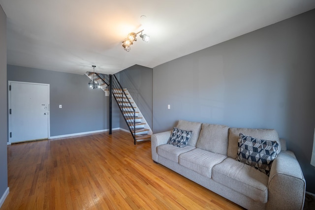 17524 89th Ave Unit C, Jamaica, NY 11432 - living area with stairs, light wood-type flooring, baseboards, and a chandelier
