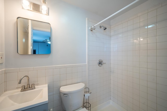 17524 89th Ave Unit C, Jamaica, NY 11432 - full bath featuring tiled shower, toilet, vanity, tile walls, and a wainscoted wall