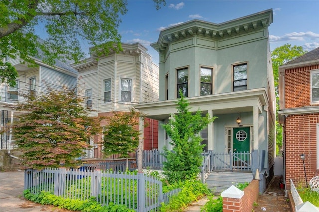 243 E 234th St, Bronx, NY 10470 - italianate-style house featuring a porch and stucco siding