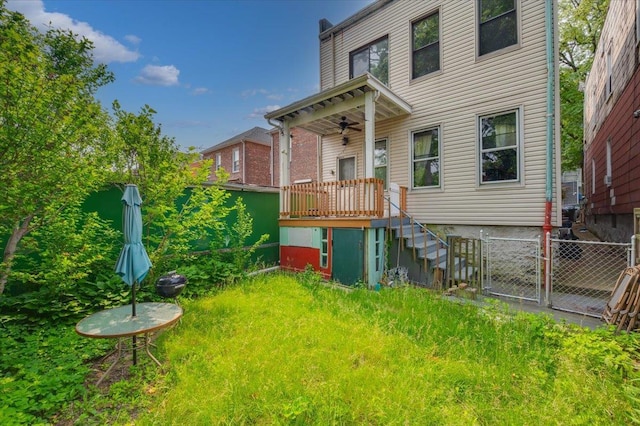 243 E 234th St, Bronx, NY 10470 - rear view of house with ceiling fan, a fenced backyard, a gate, and stairway