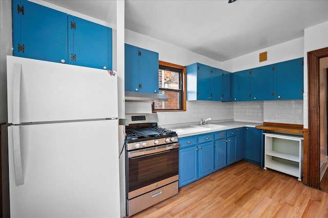 243 E 234th St, Bronx, NY 10470 - kitchen with freestanding refrigerator, gas stove, blue cabinetry, a sink, and backsplash