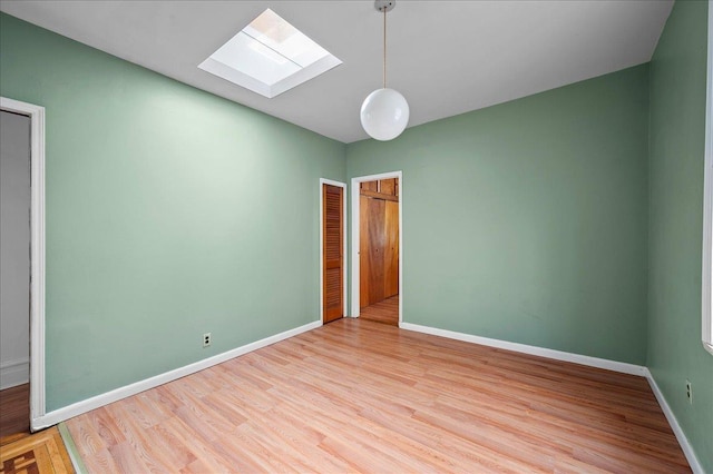 243 E 234th St, Bronx, NY 10470 - spare room featuring a skylight, wood finished floors, and baseboards