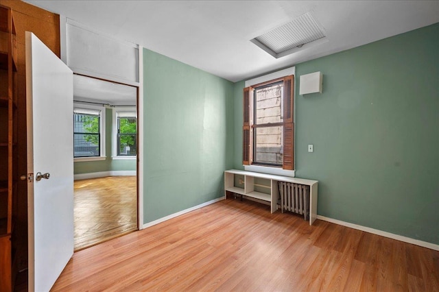 243 E 234th St, Bronx, NY 10470 - empty room with light wood-style flooring, baseboards, and radiator heating unit