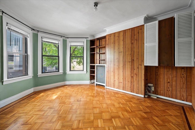 243 E 234th St, Bronx, NY 10470 - unfurnished room with baseboards and wood walls