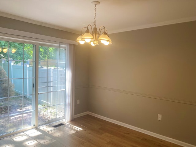 122 Oak Park Ter, Wappingers Falls, NY 12590 - unfurnished room with a chandelier, baseboards, wood finished floors, and ornamental molding