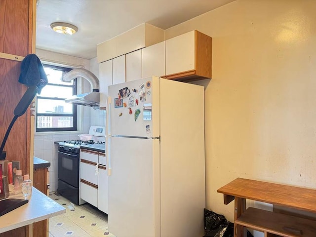 38-15 149th St Unit 6S, Flushing, NY 11354 - kitchen with freestanding refrigerator, gas range oven, white cabinetry, and light countertops
