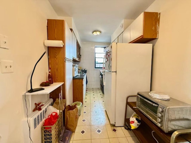 38-15 149th St Unit 6S, Flushing, NY 11354 - kitchen with freestanding refrigerator, light tile patterned floors, and stove