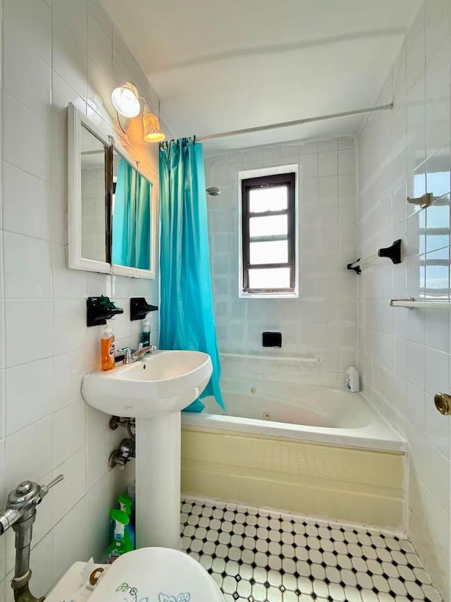 38-15 149th St Unit 6S, Flushing, NY 11354 - full bathroom featuring tile walls, a combined bath / shower with jetted tub, toilet, and tile patterned floors