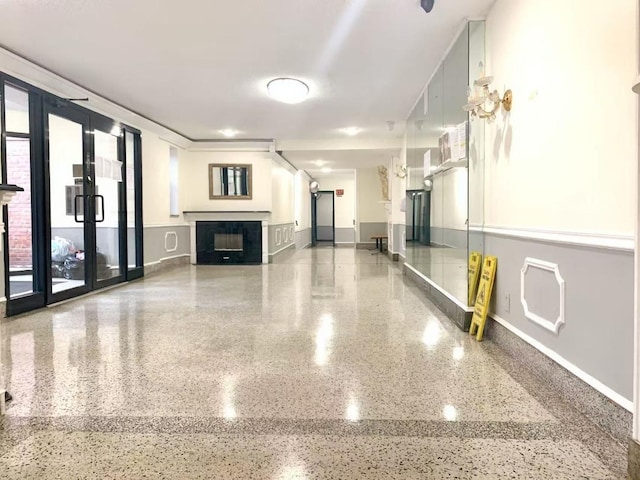 38-15 149th St Unit 6S, Flushing, NY 11354 - unfurnished living room featuring speckled floor, baseboards, and a fireplace