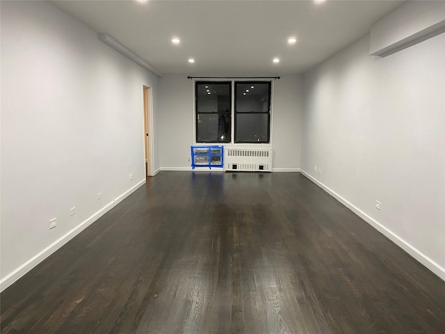 138-70 Elder Ave Unit 7H, Flushing, NY 11355 - unfurnished living room with baseboards, radiator heating unit, recessed lighting, and dark wood-style floors