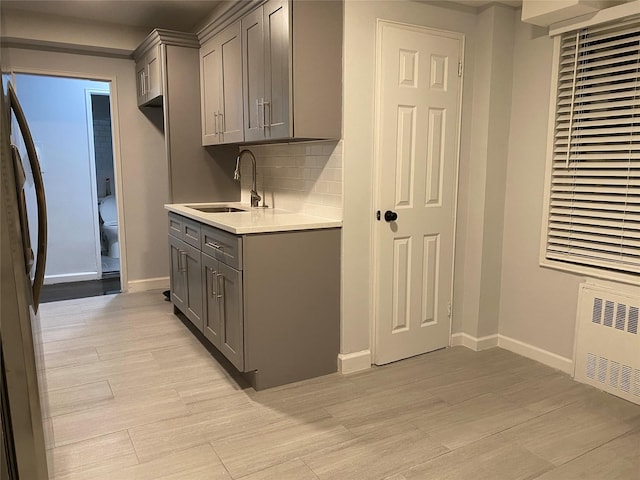 138-70 Elder Ave Unit 7H, Flushing, NY 11355 - kitchen featuring gray cabinetry, a sink, light countertops, and fridge
