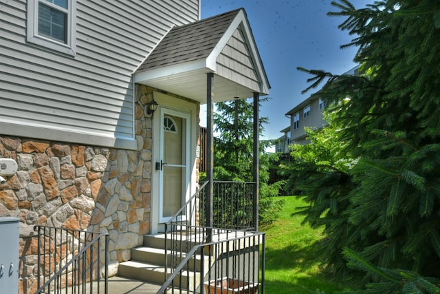 2 Hidden Creek Blvd, Monroe, NY 10950 - property entrance with stone siding, a lawn, and a shingled roof