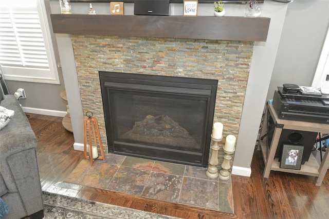 2 Hidden Creek Blvd, Monroe, NY 10950 - detailed view of baseboards, a glass covered fireplace, and wood finished floors
