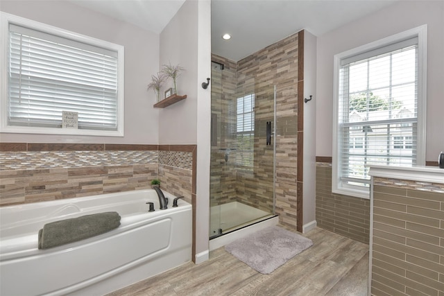 2 Hidden Creek Blvd, Monroe, NY 10950 - full bathroom with a bath, a shower stall, wood finished floors, tile walls, and healthy amount of natural light