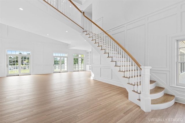 44 Club Ln, Remsenburg, NY 11960 - stairs with a decorative wall, wood finished floors, high vaulted ceiling, and recessed lighting