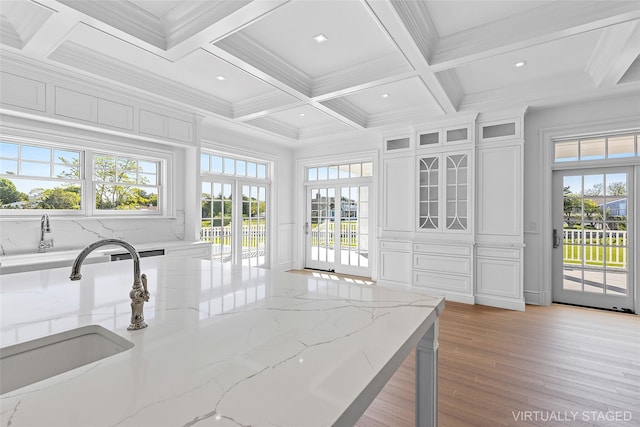 44 Club Ln, Remsenburg, NY 11960 - kitchen featuring a sink, coffered ceiling, light wood-style flooring, white cabinets, and beamed ceiling