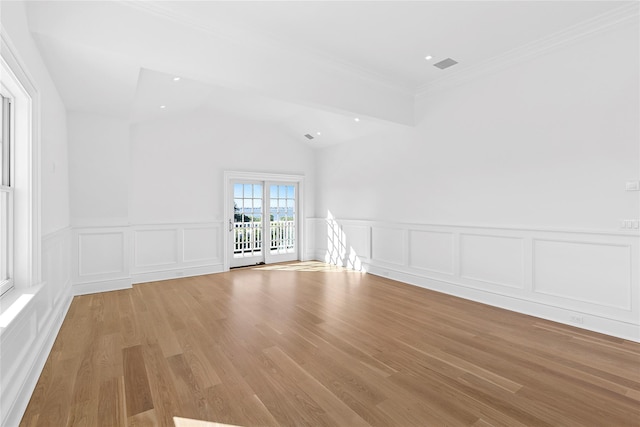 44 Club Ln, Remsenburg, NY 11960 - unfurnished room with a decorative wall, light wood-style flooring, wainscoting, crown molding, and vaulted ceiling