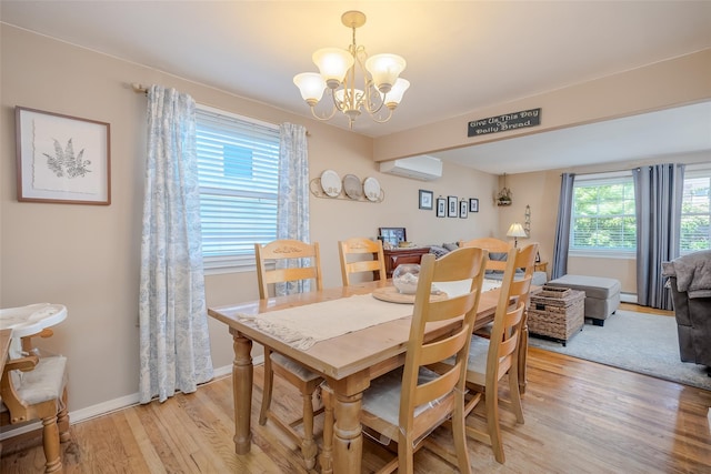 58 Hooper St, Port Jefferson Station, NY 11776 - dining room with light wood-style floors, a chandelier, a wall unit AC, baseboards, and a baseboard radiator