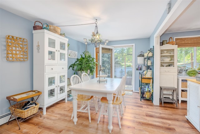 58 Hooper St, Port Jefferson Station, NY 11776 - dining space with plenty of natural light, light wood-style flooring, a chandelier, and a baseboard radiator