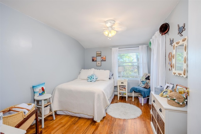 58 Hooper St, Port Jefferson Station, NY 11776 - bedroom with vaulted ceiling, light wood-style flooring, and a ceiling fan