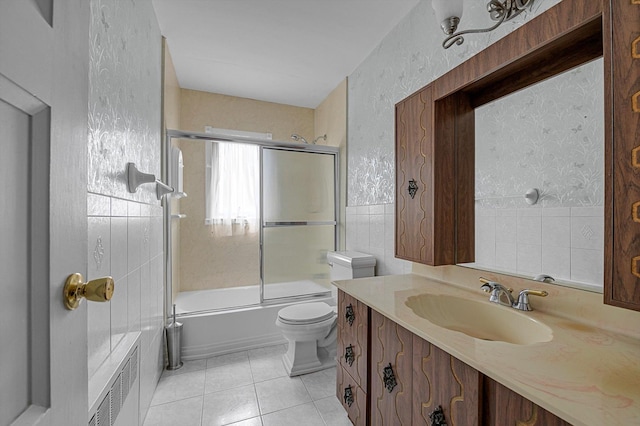 116 Intervale Ave, Farmingdale, NY 11735 - bathroom featuring vanity, toilet, enclosed tub / shower combo, tile patterned flooring, and tile walls