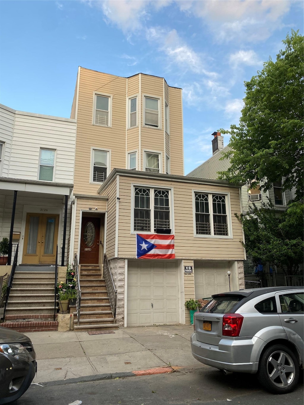 2124 Glebe Ave, Bronx, NY 10462 - view of front of house featuring a garage, driveway, and french doors