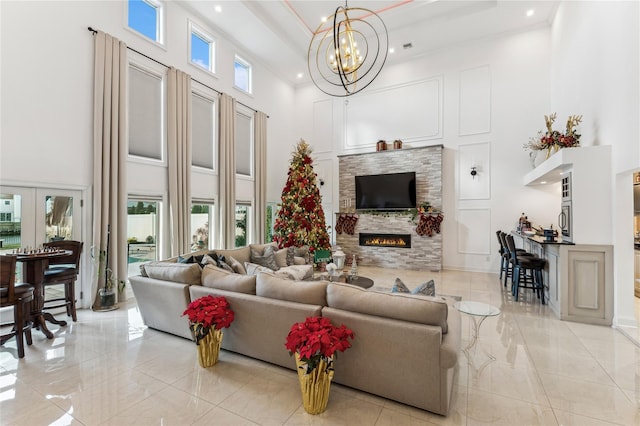 2854 Whaleneck Dr, Merrick, NY 11566 - living area with a towering ceiling, light marble finish flooring, recessed lighting, a stone fireplace, and a chandelier