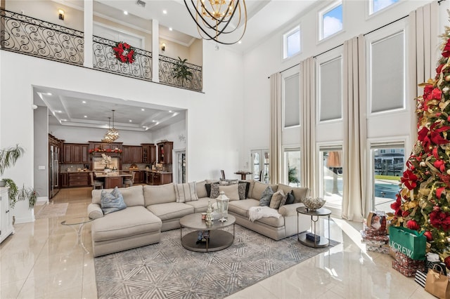 2854 Whaleneck Dr, Merrick, NY 11566 - living area featuring a chandelier, a towering ceiling, light marble finish floors, ornamental molding, and recessed lighting