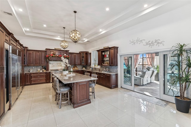 2854 Whaleneck Dr, Merrick, NY 11566 - kitchen with premium appliances, backsplash, a breakfast bar area, a chandelier, and recessed lighting