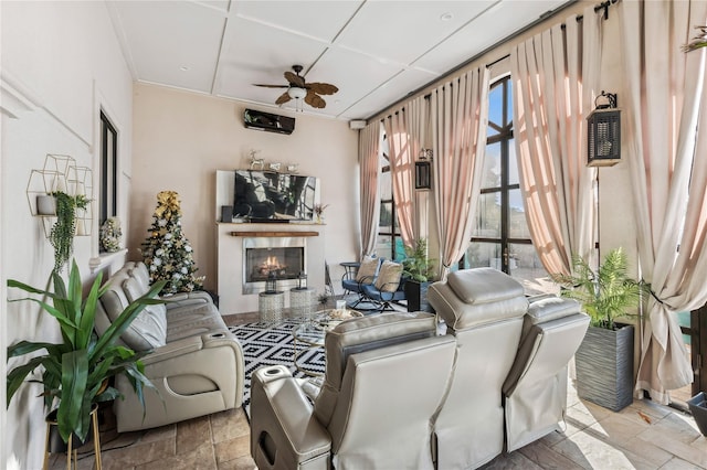 2854 Whaleneck Dr, Merrick, NY 11566 - living area featuring ceiling fan, a lit fireplace, and stone tile floors