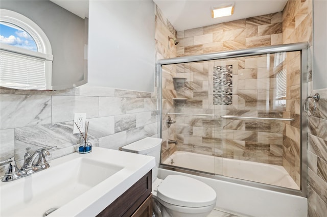 2854 Whaleneck Dr, Merrick, NY 11566 - full bath with vanity, toilet, enclosed tub / shower combo, tile walls, and a wainscoted wall