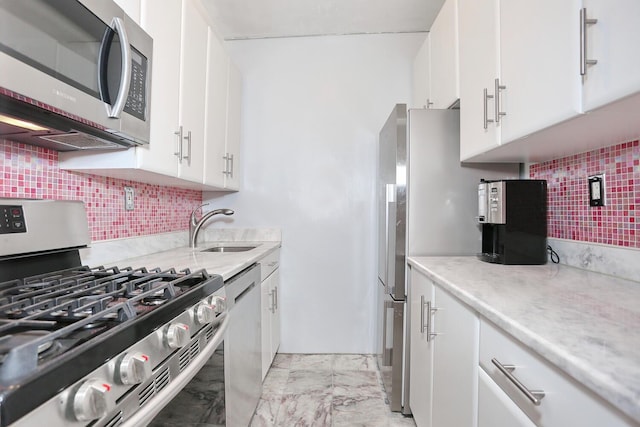 311 71st St E Unit 10A, New York Manhattan, NY 10021 - kitchen featuring stainless steel appliances, white cabinets, and tasteful backsplash
