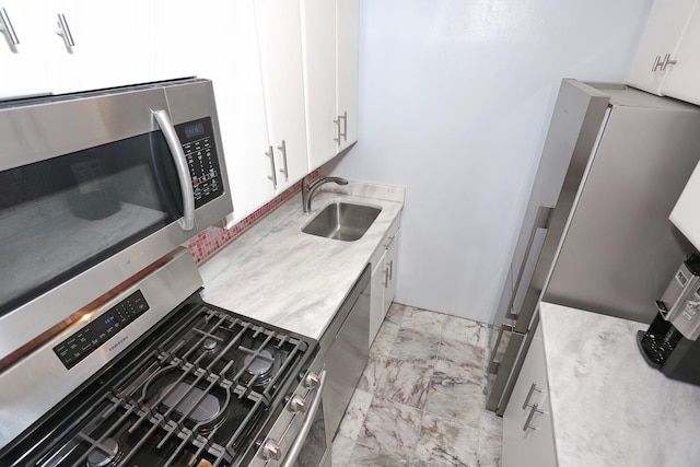 311 71st St E Unit 10A, New York Manhattan, NY 10021 - kitchen with stainless steel appliances, light countertops, white cabinetry, and light marble finish floors